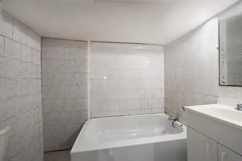 a bathroom with a bathtub and a sink
