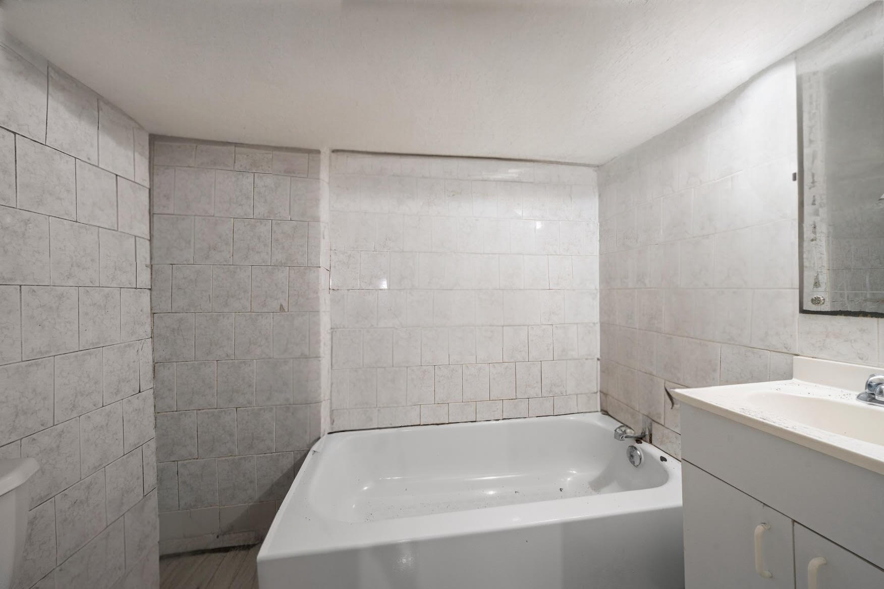 1419 East 54th Street Brooklyn, NY 11234 - Photo 14 of 19 a bathroom with a bathtub and a sink