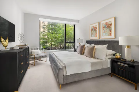a bed room with a bed and a night stand