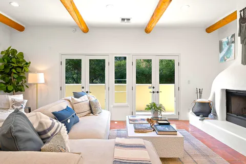 a living room with furniture tv and a large window