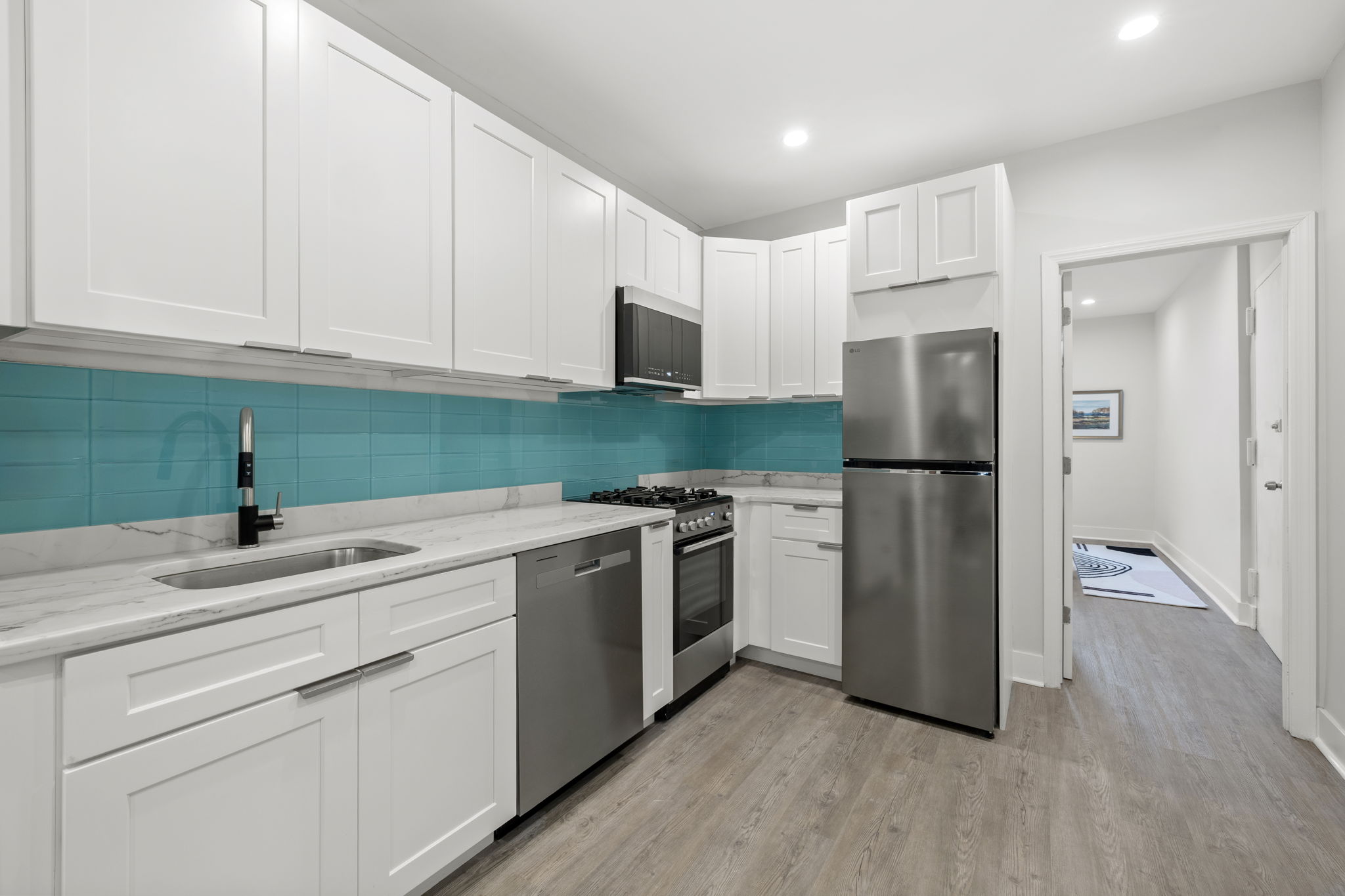 1604 Lexington Avenue Manhattan, NY 10029 - Photo 5 of 12 a kitchen with a refrigerator and a sink