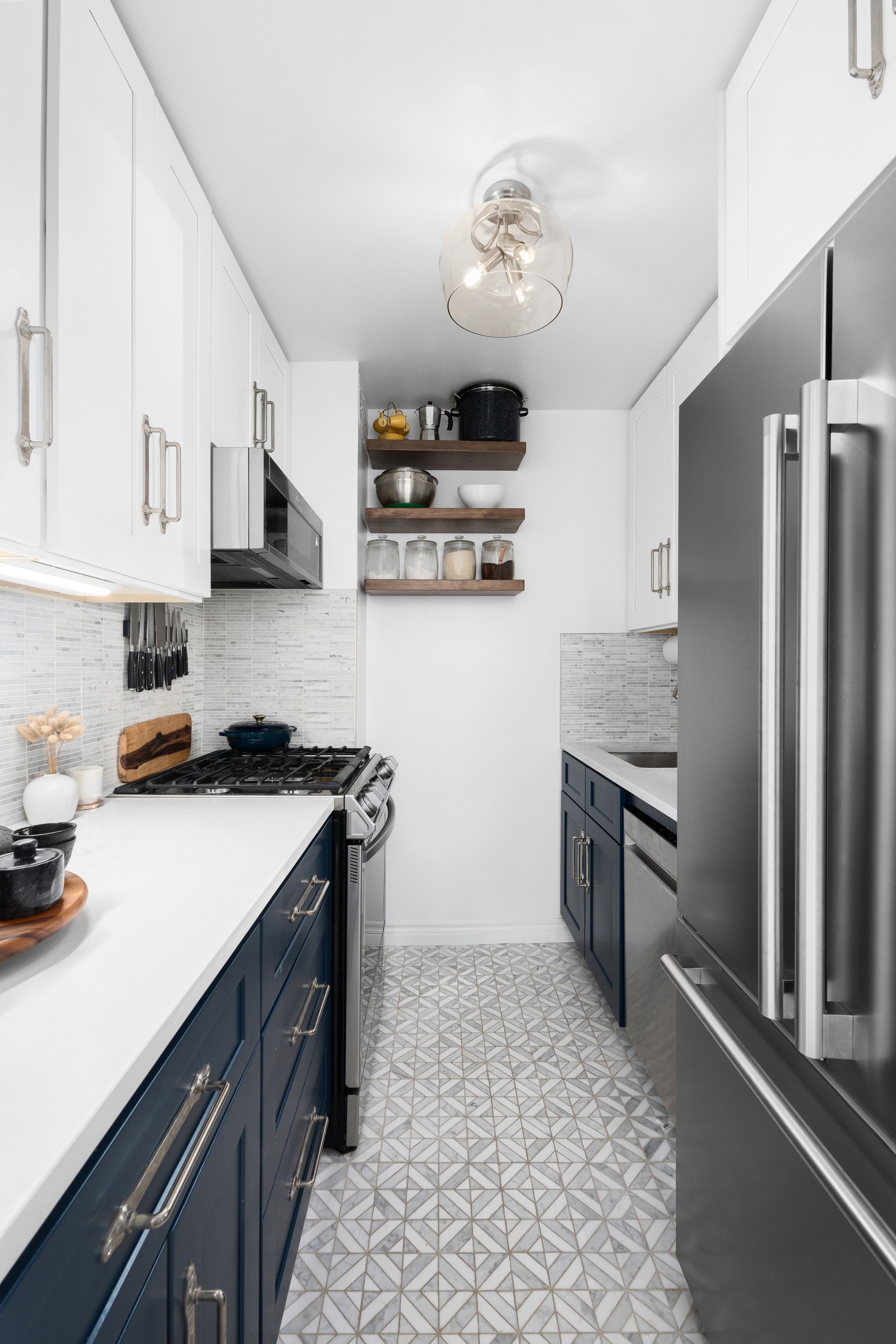 333 East 66th Street, Unit 8C Manhattan, NY 10065 - Photo 6 of 13 a kitchen with stainless steel appliances granite countertop a refrigerator a stove and a sink with wooden floor