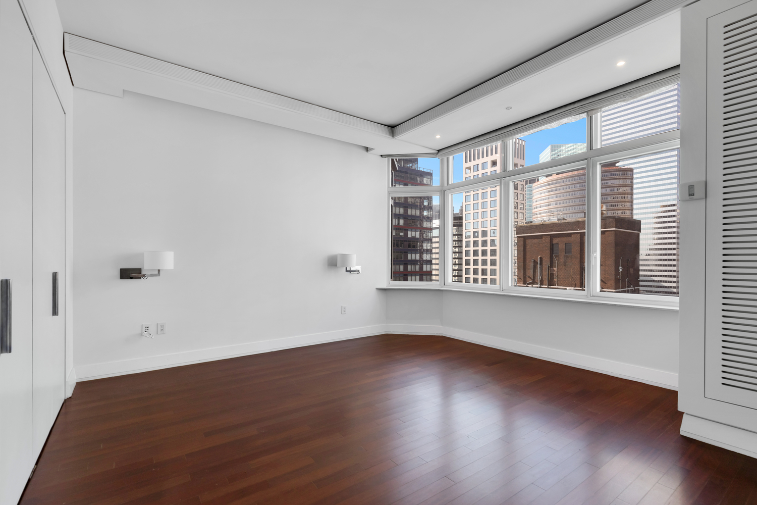 300 East 55th Street, Unit 28B Manhattan, NY 10022 - Photo 4 of 12 a view of an empty room with wooden floor and a window