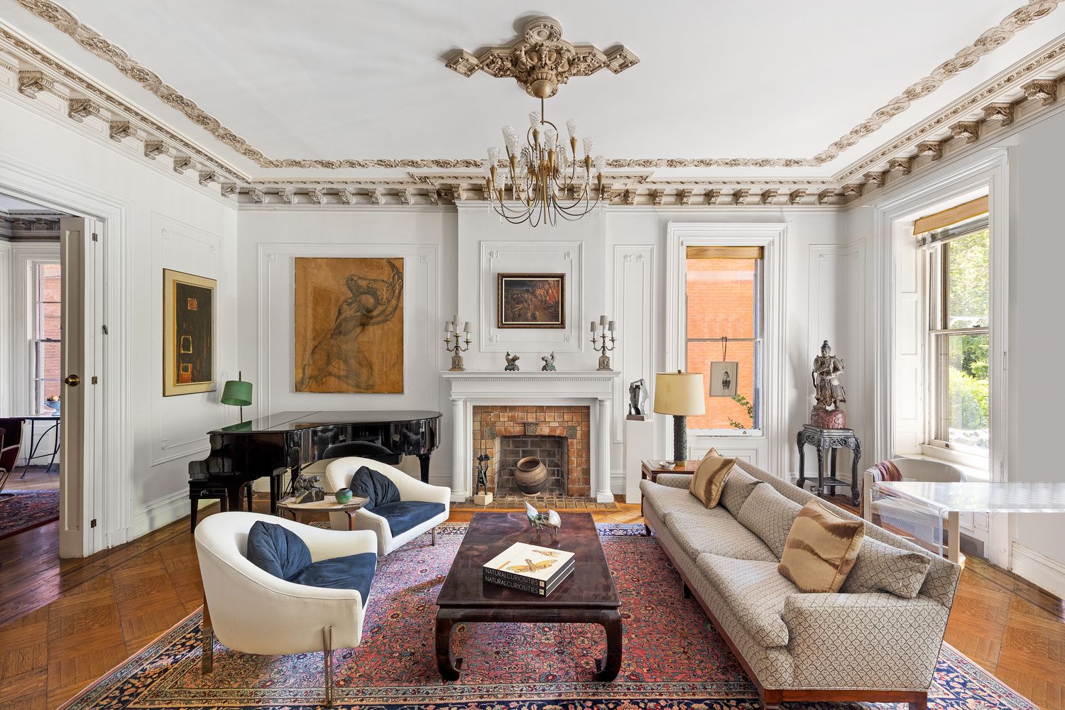315 Washington Avenue Brooklyn, NY 11205 - Photo 5 of 38 a living room with furniture a chandelier and a fireplace