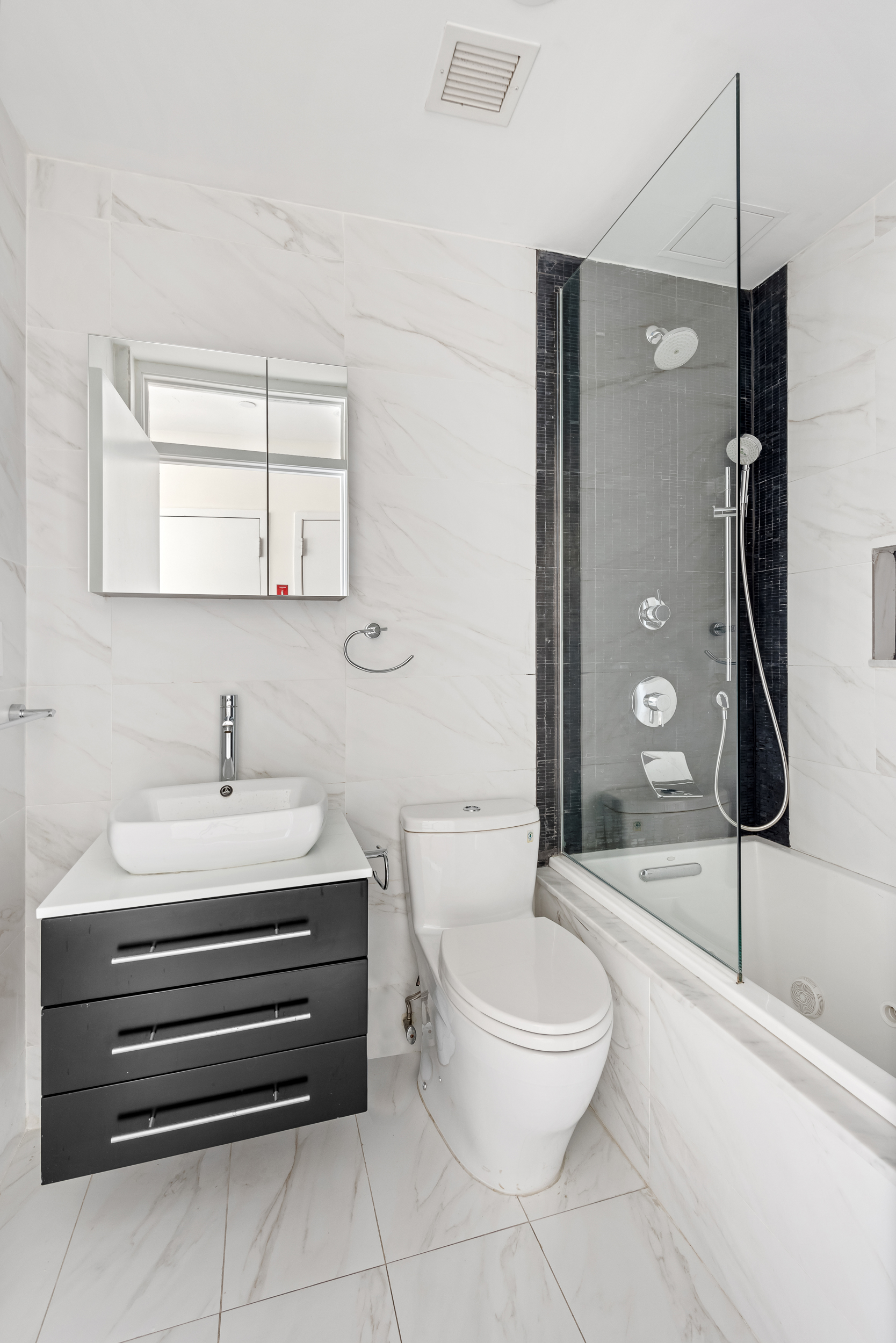 176 Mulberry Street, Unit 5 Manhattan, NY 10013 - Photo 11 of 12 a bathroom with a sink a toilet and shower