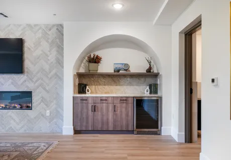a living room with a fireplace and a wooden floor