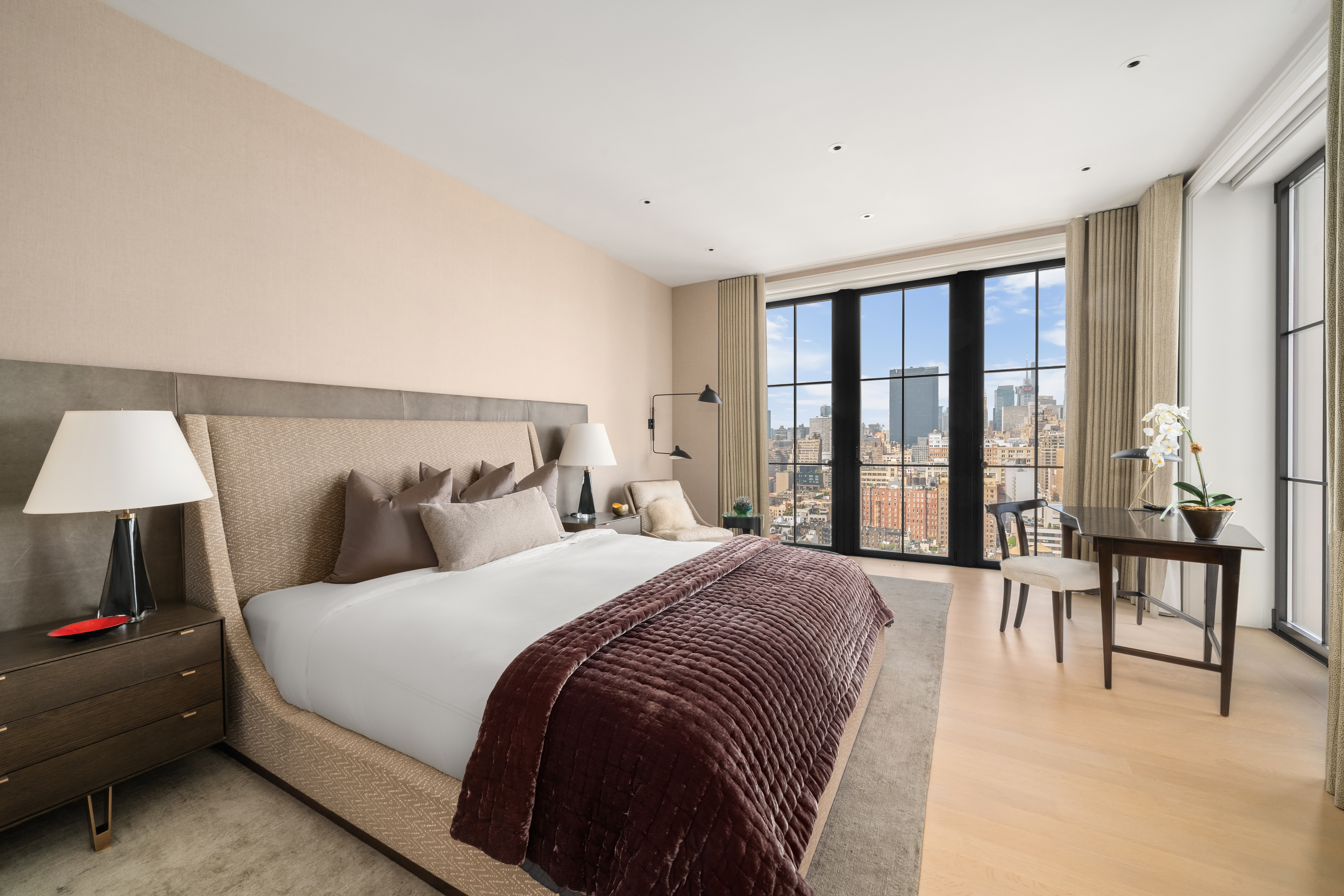 212 West 18th Street, Unit 19C Manhattan, NY 10011 - Photo 10 of 27 a spacious bedroom with a bed and a large window