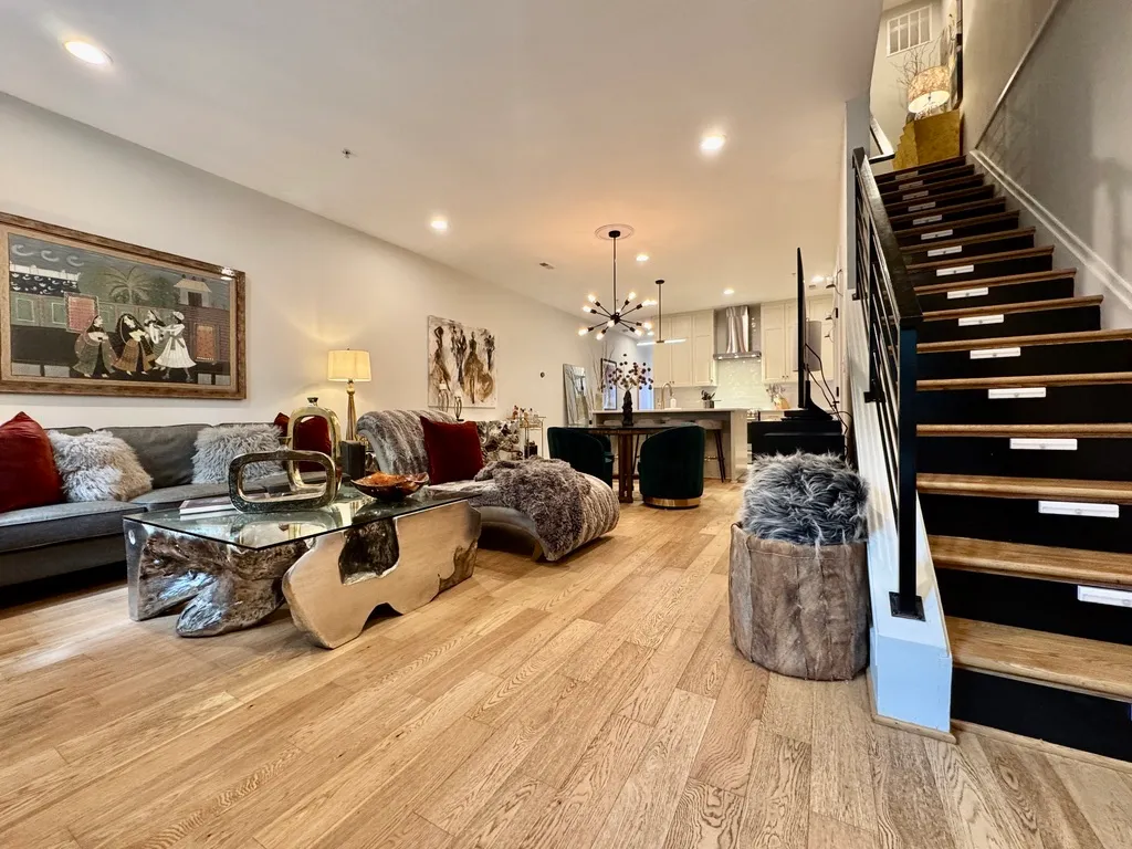 a living room with lots of furniture and wooden floor