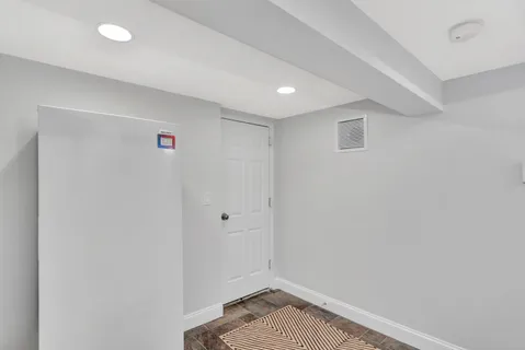 a bathroom with a granite countertop toilet sink and mirror