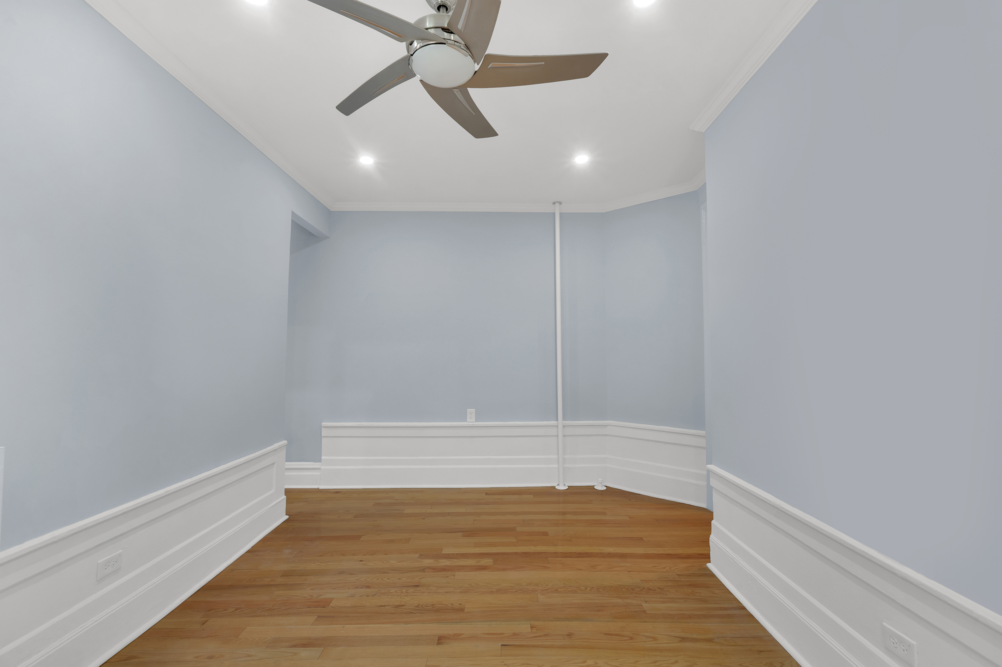 100 Hamilton Place, Unit 2F Manhattan, NY 10031 - Photo 11 of 21 an empty room with wooden floor and windows
