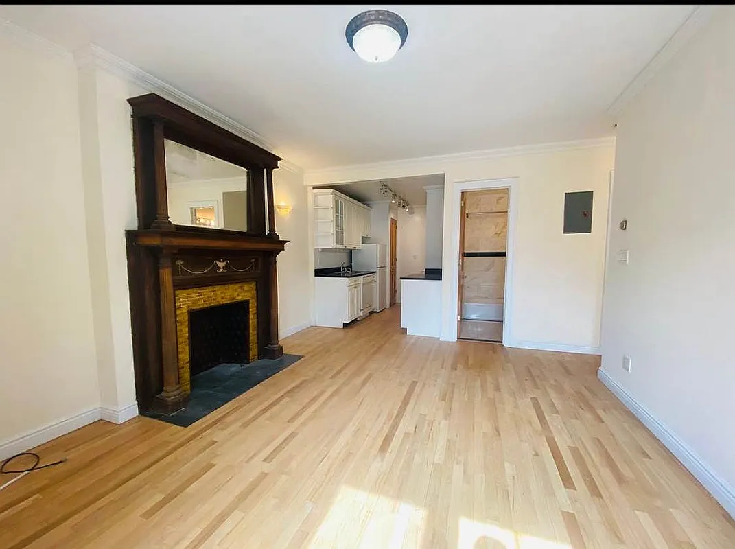 305 West 91st Street, Unit 4F Manhattan, NY 10024 - Photo 4 of 11 a view of empty room with wooden floor and fireplace