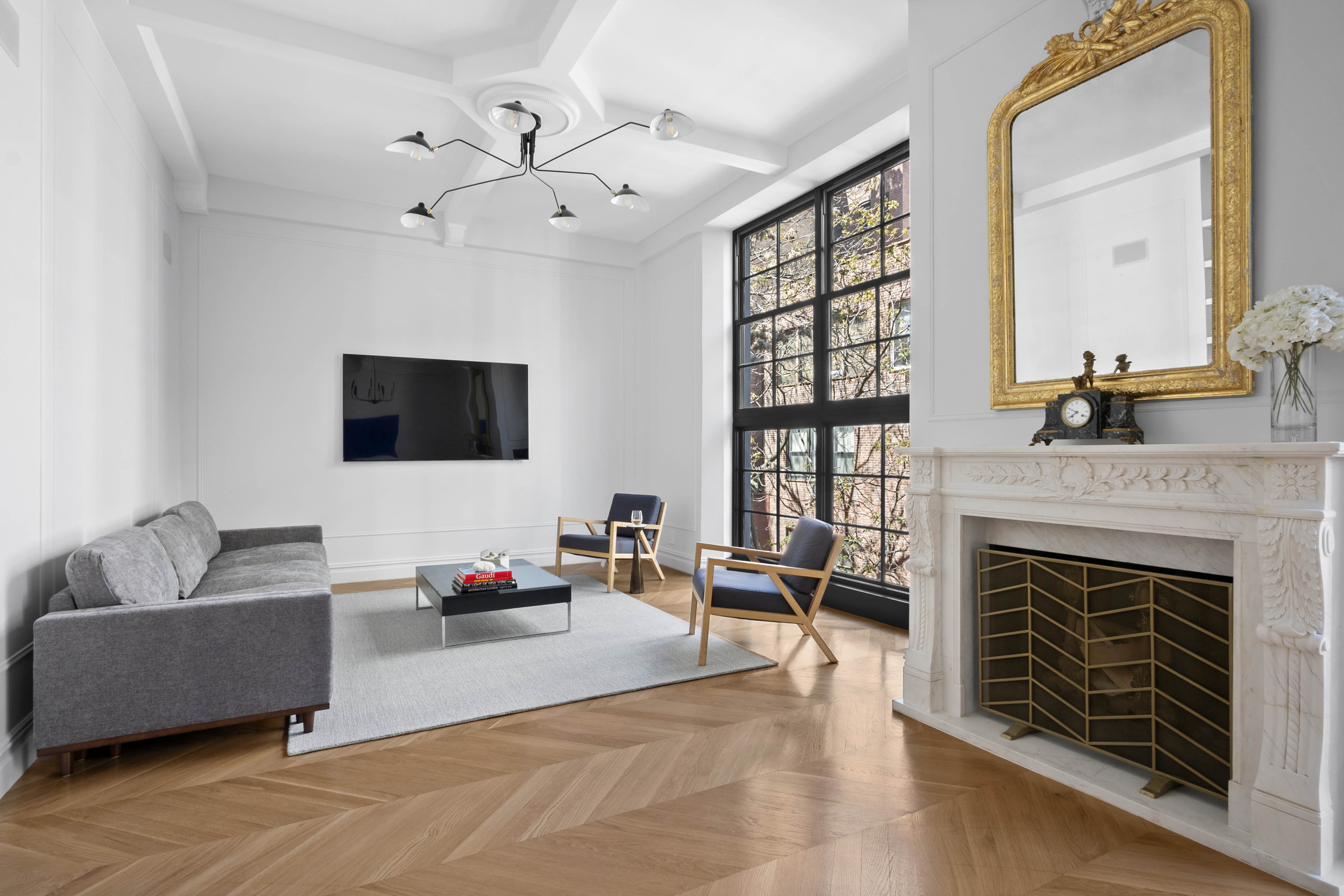 33 West 67th Street, Unit 4M Manhattan, NY 10023 - Photo 4 of 16 a living room with furniture and a fireplace