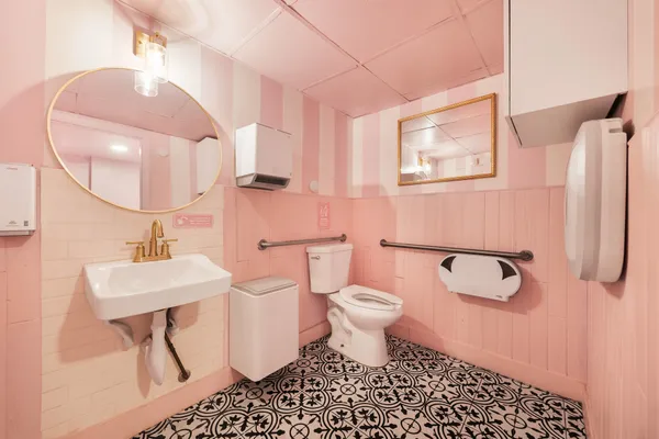 a bathroom with a sink toilet and a mirror