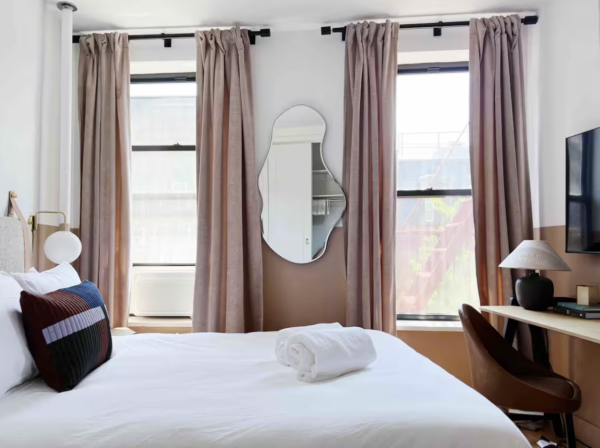 9 Spring Street, Unit 23 Manhattan, NY 10012 - Photo 5 of 7 a bedroom with a bed and a window