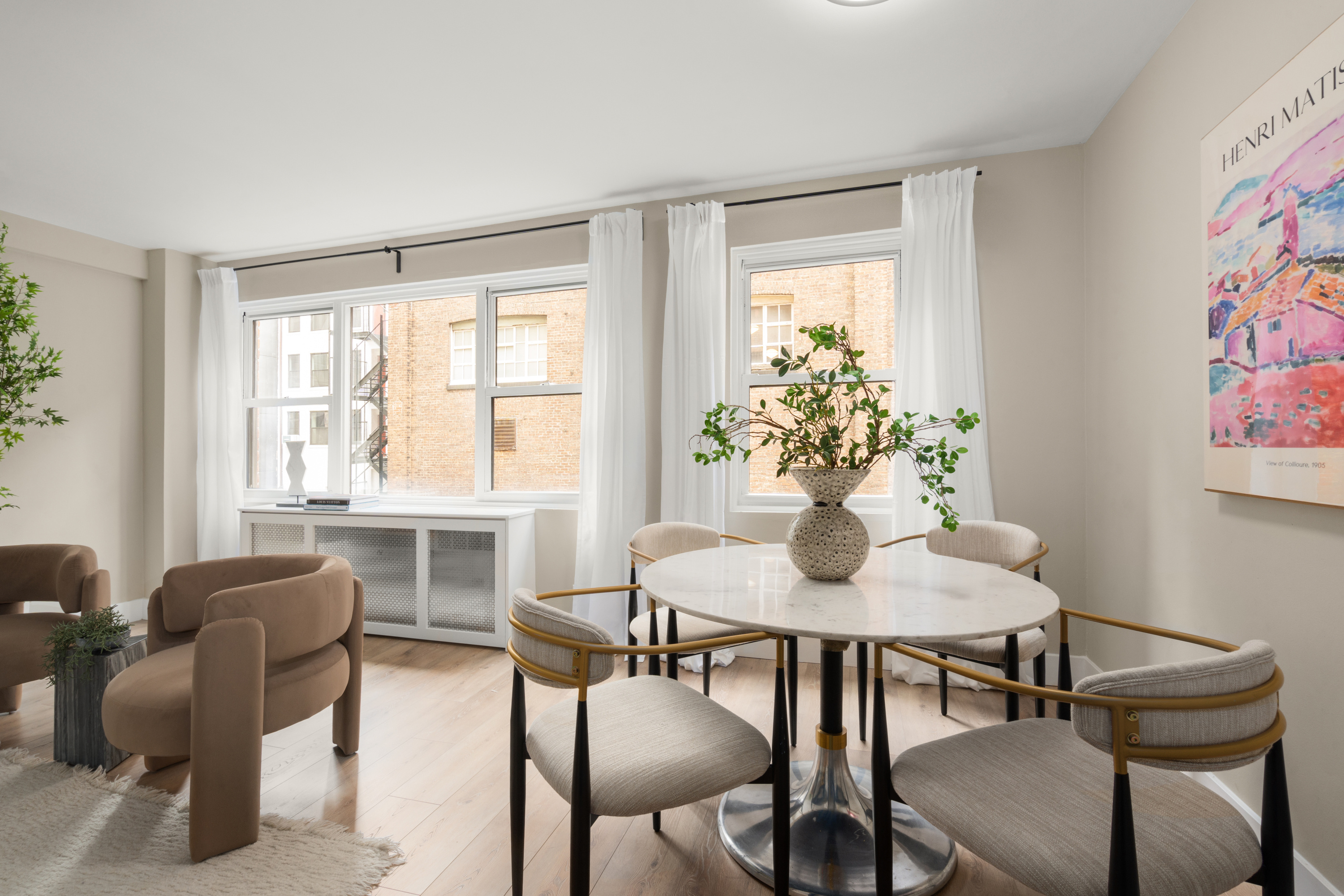 347 East 53rd Street, Unit 2C Manhattan, NY 10022 - Photo 9 of 18 a dining room with furniture and wooden floor