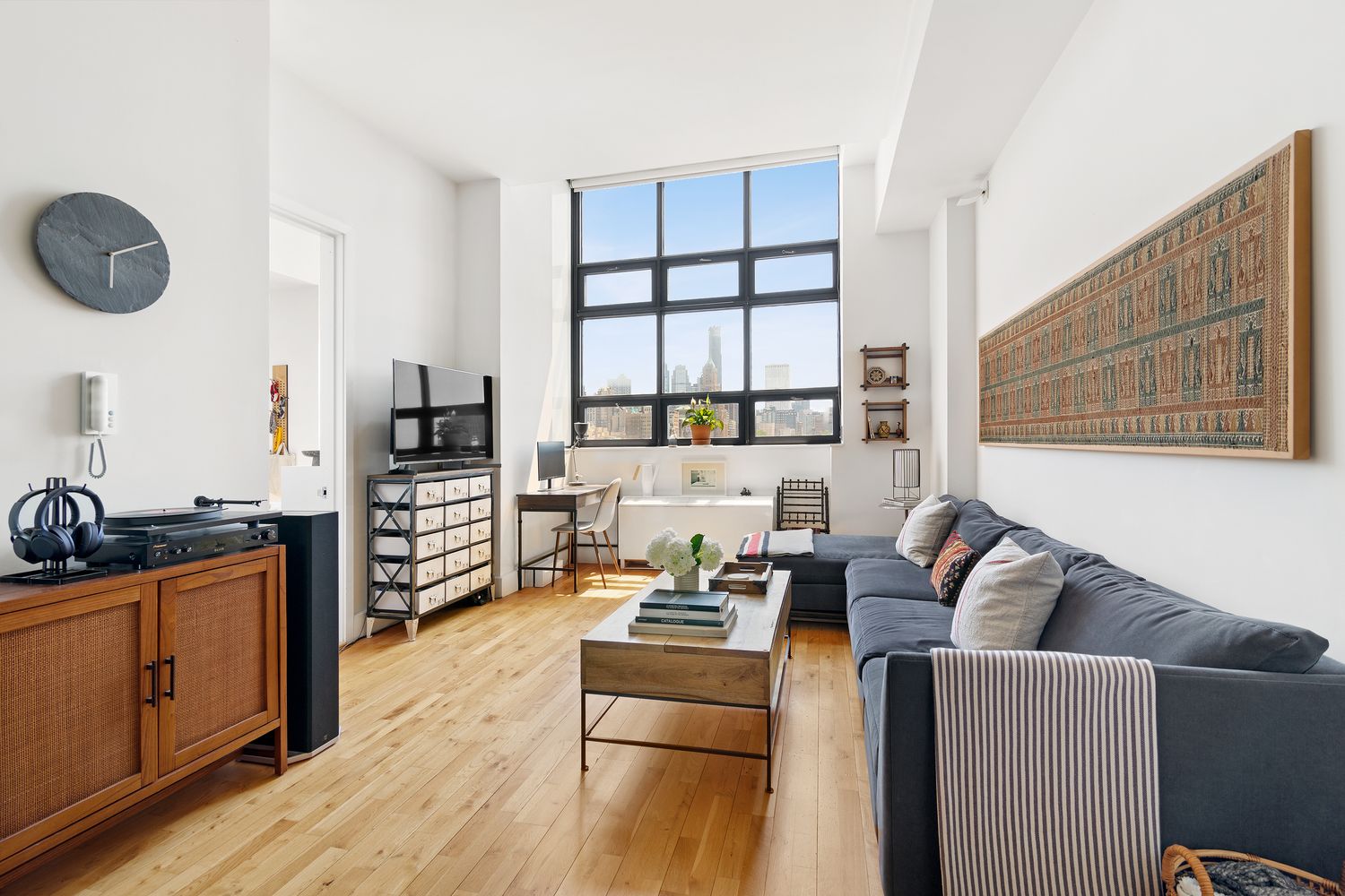 360 Furman Street, Unit 906 Brooklyn, NY 11201 - Photo 3 of 7 a living room with furniture and a flat screen tv