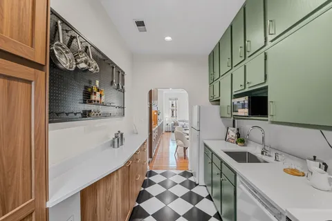 a kitchen with stainless steel appliances a stove a sink and a refrigerator