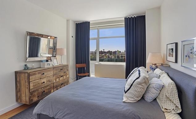 189 Schermerhorn Street, Unit 7D Brooklyn, NY 11201 - Photo 3 of 5 a bedroom with a large bed and a flat tv screen