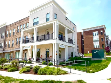 a front view of a building with a garden