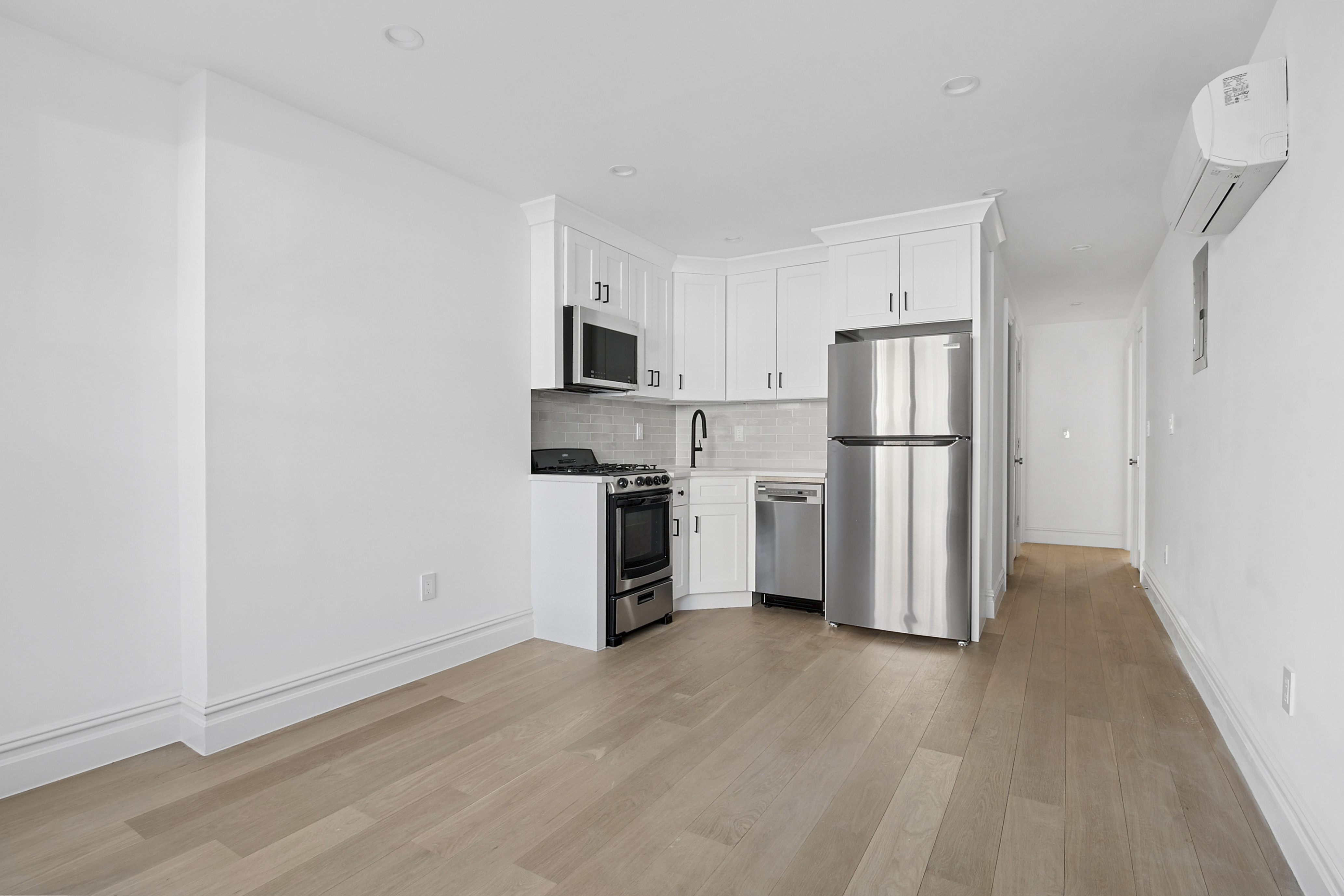 716 Decatur Street, Unit 1 Brooklyn, NY 11233 - Photo 1 of 7 a view of a kitchen with refrigerator and wooden floor