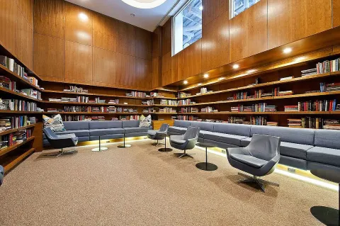 a reading room with furniture and a book shelf
