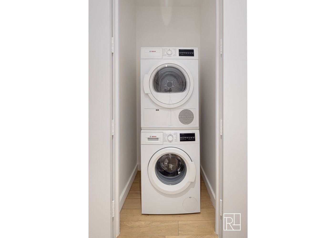 75 Wall Street, Unit 28D Manhattan, NY 10005 - Photo 11 of 35 a utility room with dryer and washer