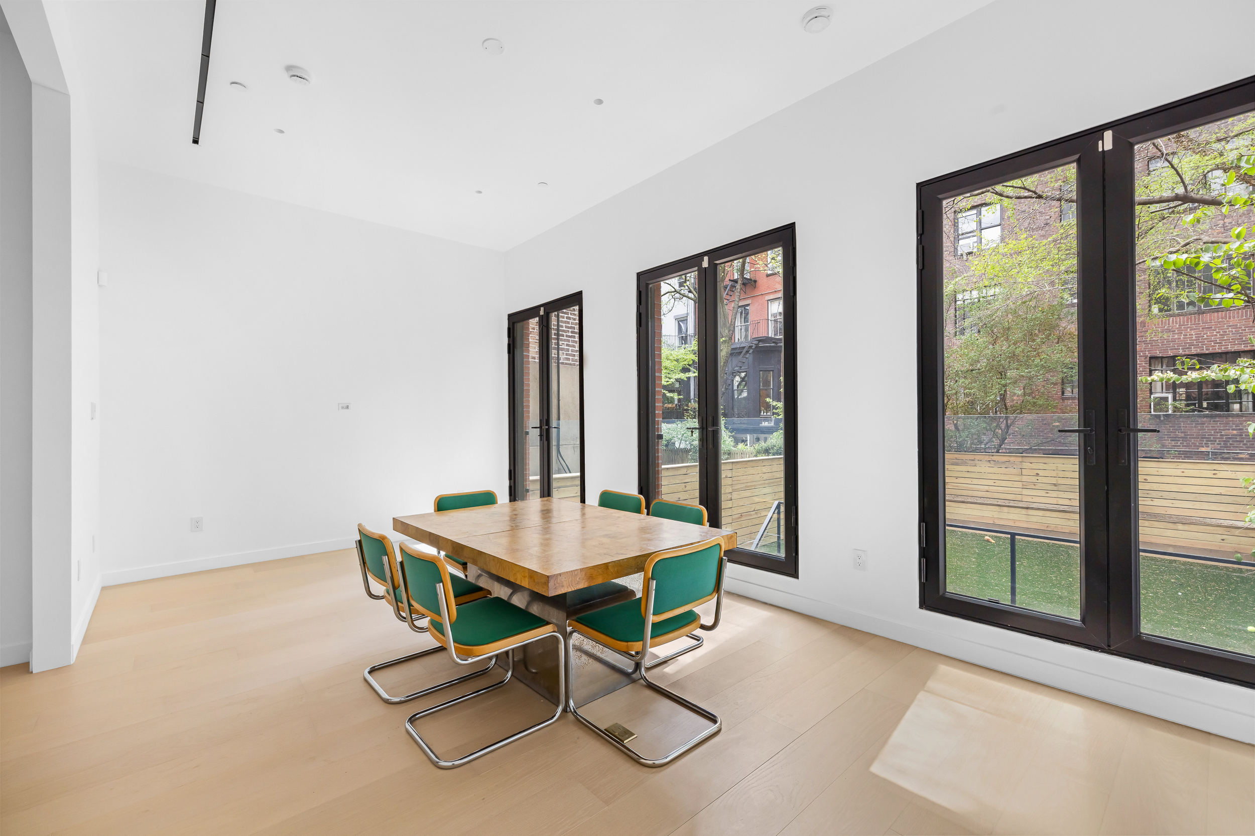 442 West 22nd Street Manhattan, NY 10011 - Photo 3 of 17 a living room with a table tennis table and a large window