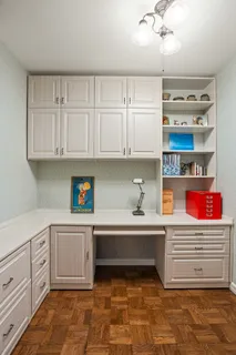 a kitchen with stainless steel appliances a cabinets and window