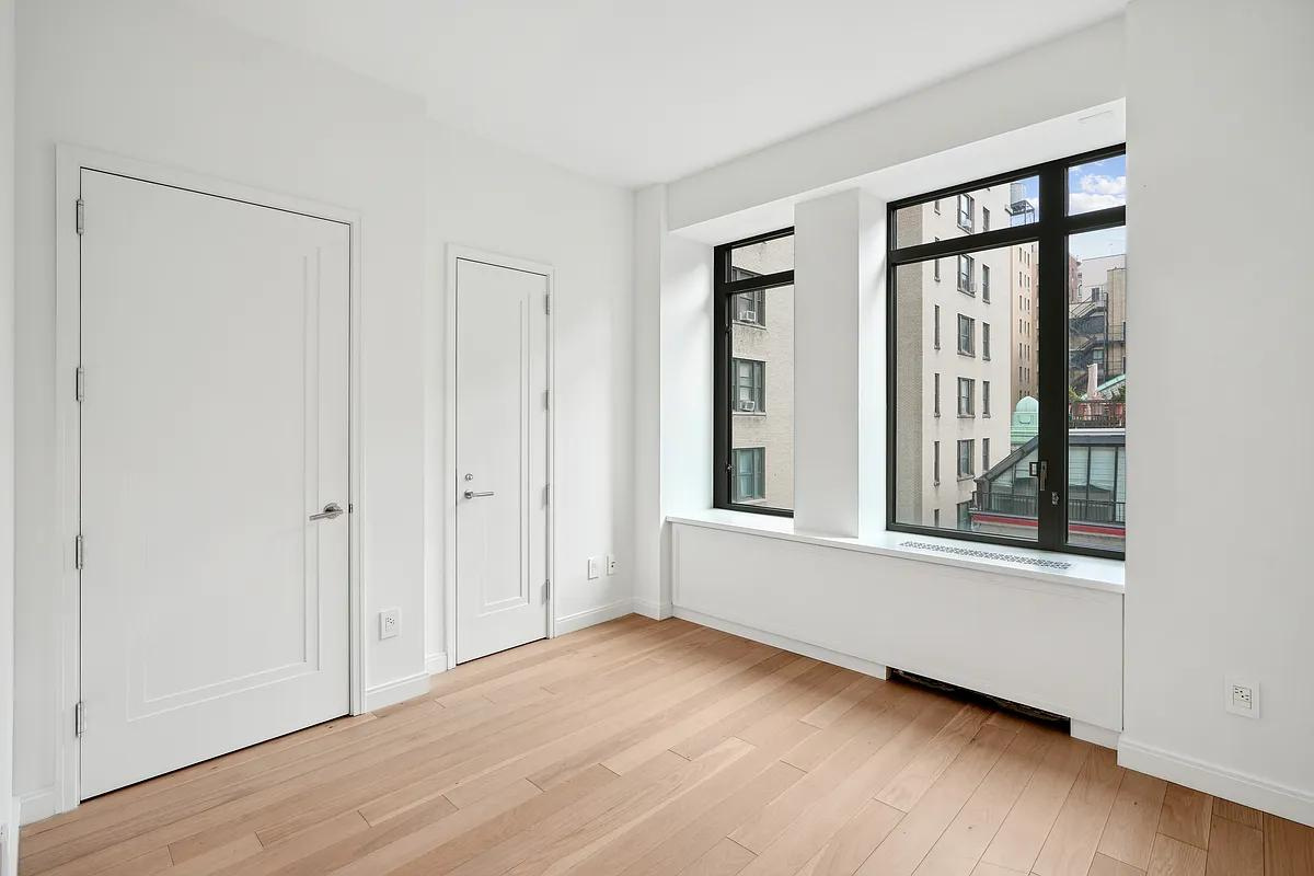 269 West 87th Street, Unit 7B Manhattan, NY 10024 - Photo 8 of 21 a view of an empty room with wooden floor and a window
