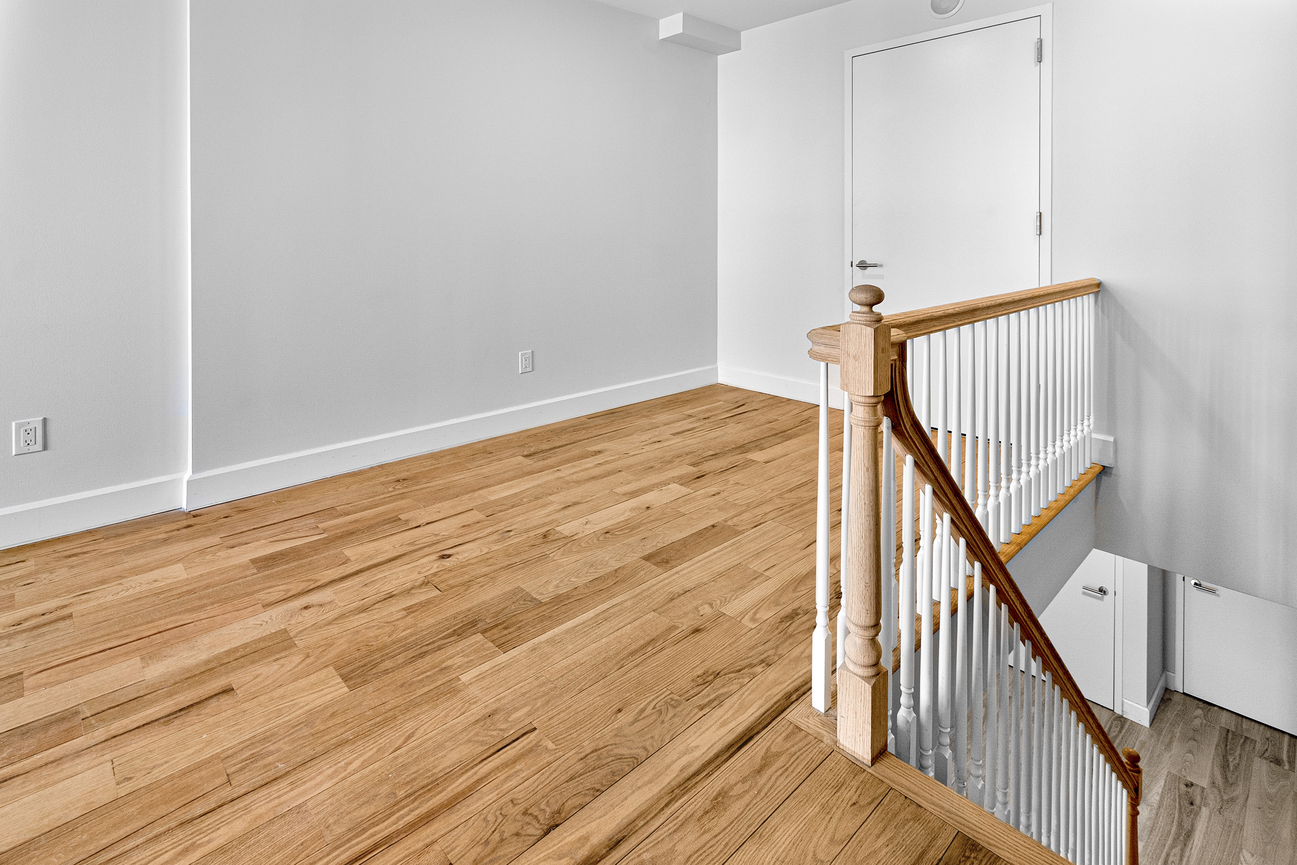 1098 Madison Street, Unit 1A Brooklyn, NY 11221 - Photo 7 of 15 a view of a hallway with wooden floor and staircase