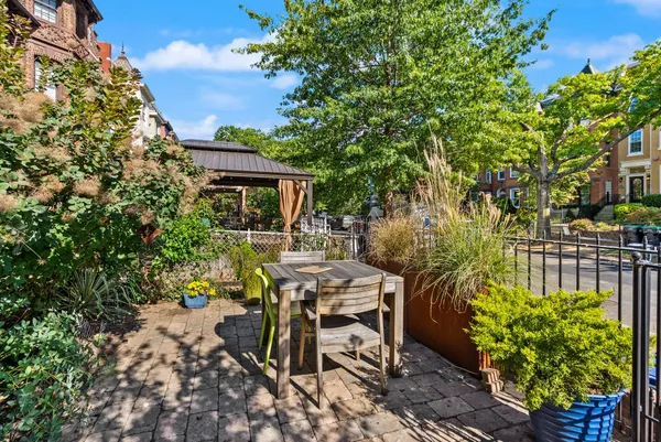 a view of a patio with table and chairs and potted plants