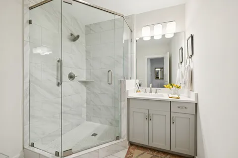 a spacious bedroom with a bed and wooden floor