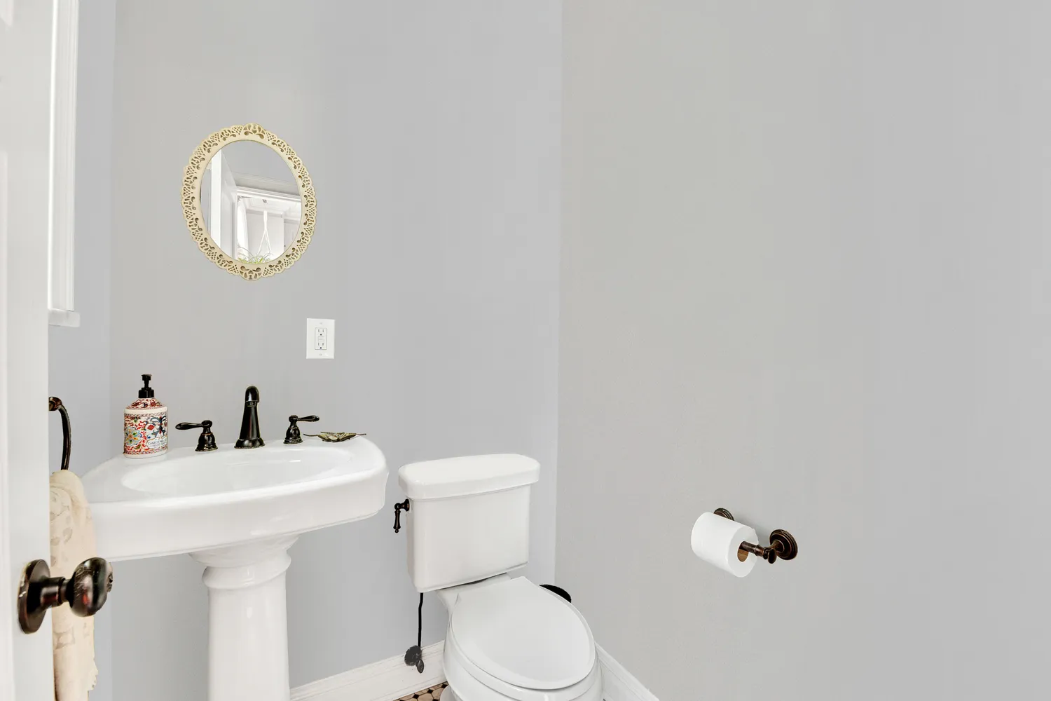 a bathroom with a toilet a sink and mirror