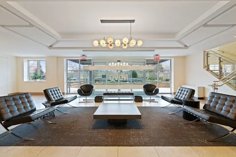 a living room with patio furniture and a large window