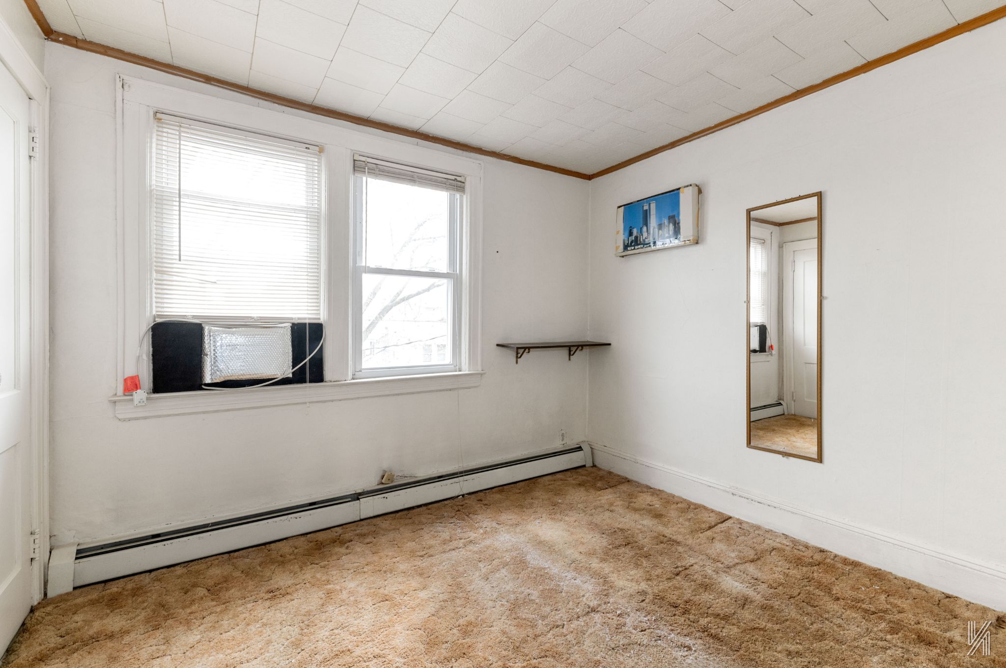 135-16 95th Street Queens, NY 11417 - Photo 13 of 21 a view of an empty room with wooden floor and a window