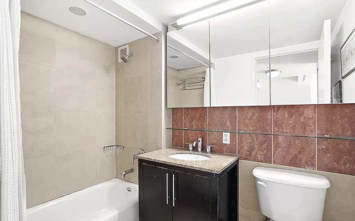 555 West 23rd Street, Unit S14E Manhattan, NY 10011 - Photo 4 of 8 a bathroom with a sink a toilet and shower