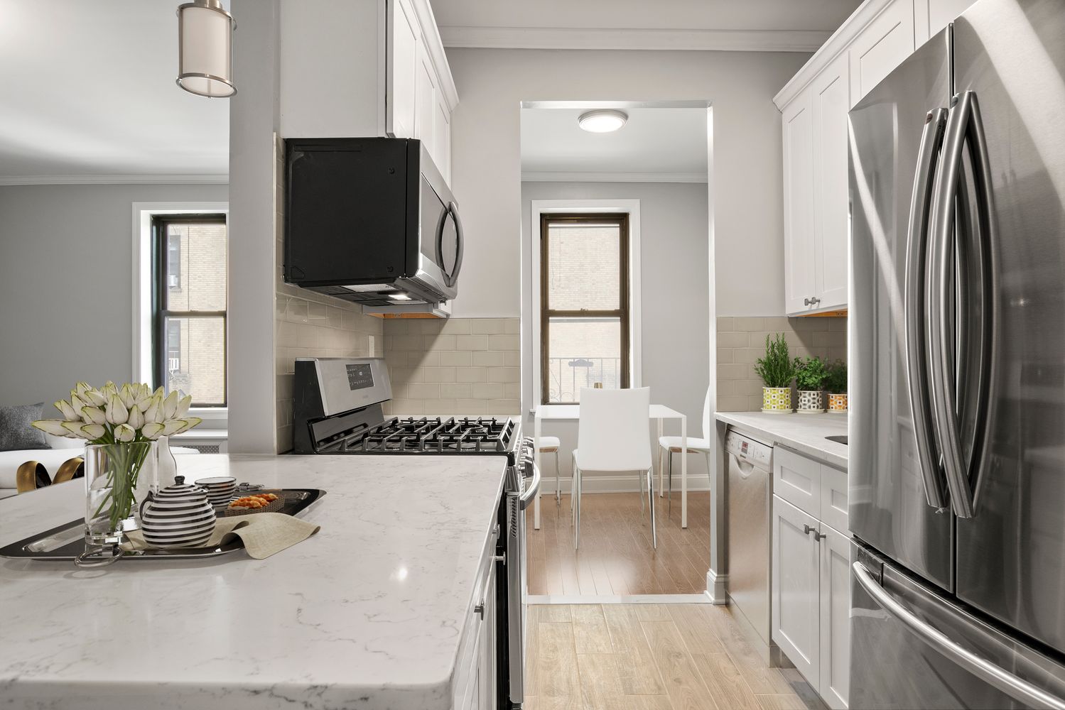 a living room with furniture a flat screen tv and a refrigerator
