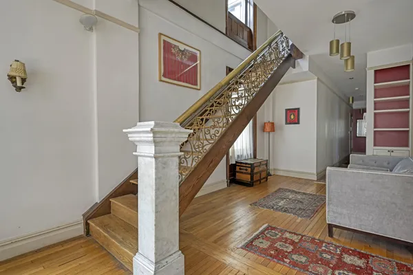 a view of entryway and hall with wooden floor