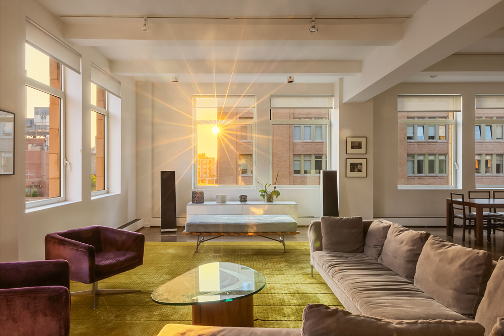 a living room with fireplace furniture and a large window