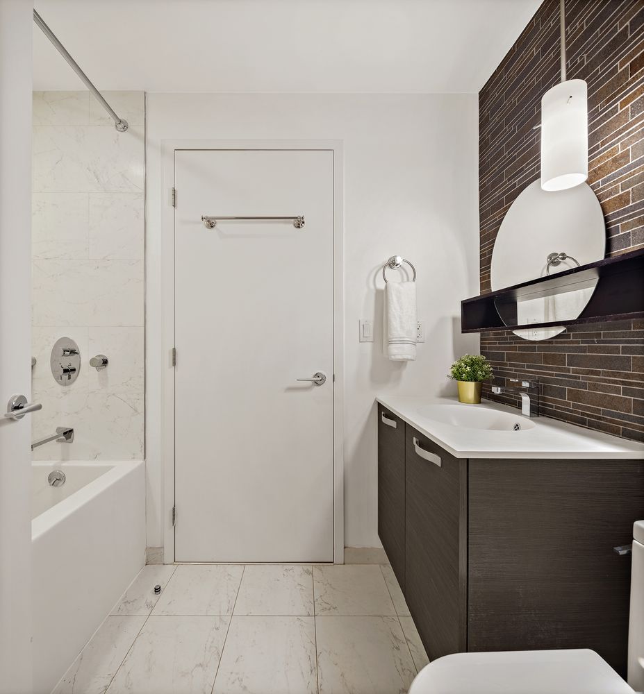 1638 8th Avenue, Unit 1B Brooklyn, NY 11215 - Photo 6 of 12 a bathroom with a sink and a mirror