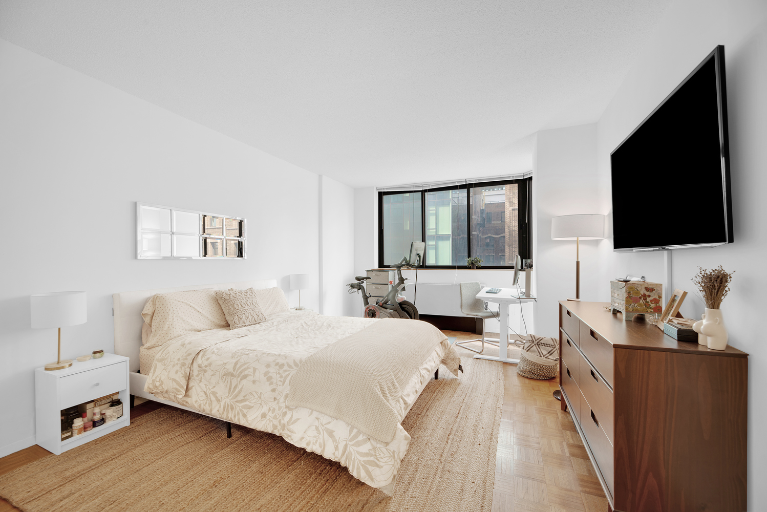 280 Park Avenue South, Unit 13M Manhattan, NY 10010 - Photo 5 of 15 a bedroom with a bed and a flat screen tv