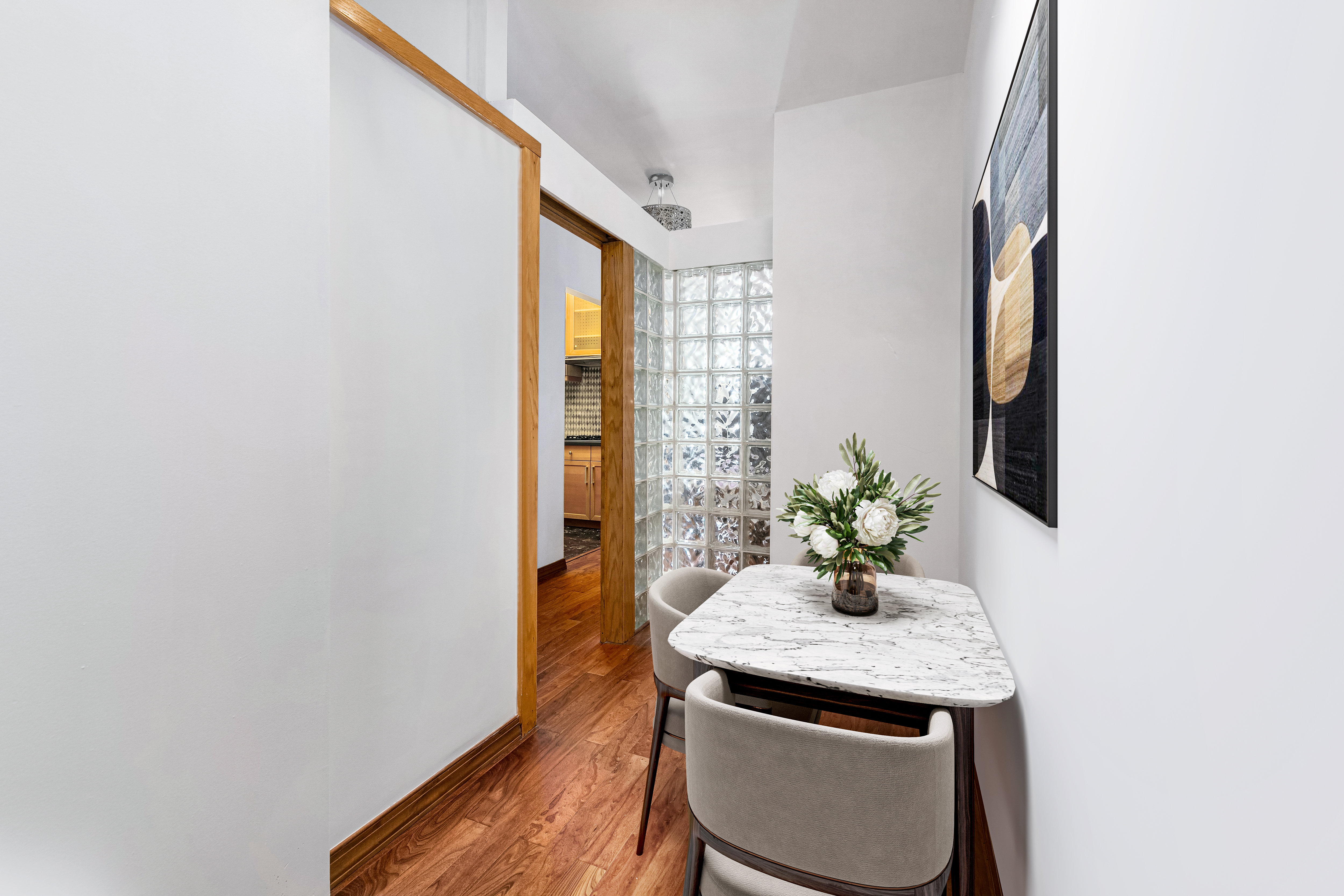 3 Hanover Square, Unit 10H Manhattan, NY 10004 - Photo 2 of 9 a dining room with window and wooden floor