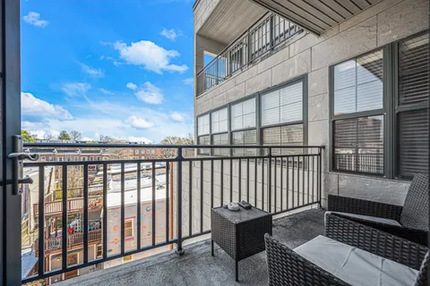 a view of a balcony with wooden floor