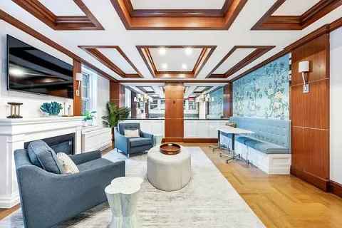 a living room with furniture and a floor to ceiling window