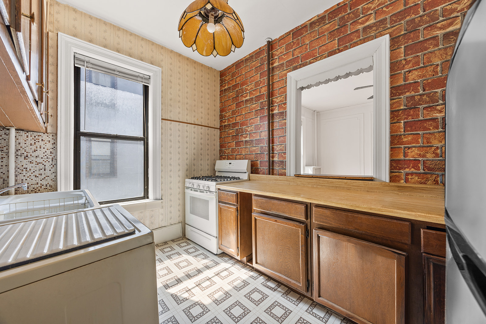 310 Windsor Place, Unit 32 Brooklyn, NY 11218 - Photo 6 of 19 a view of a bathroom with a sink and a mirror