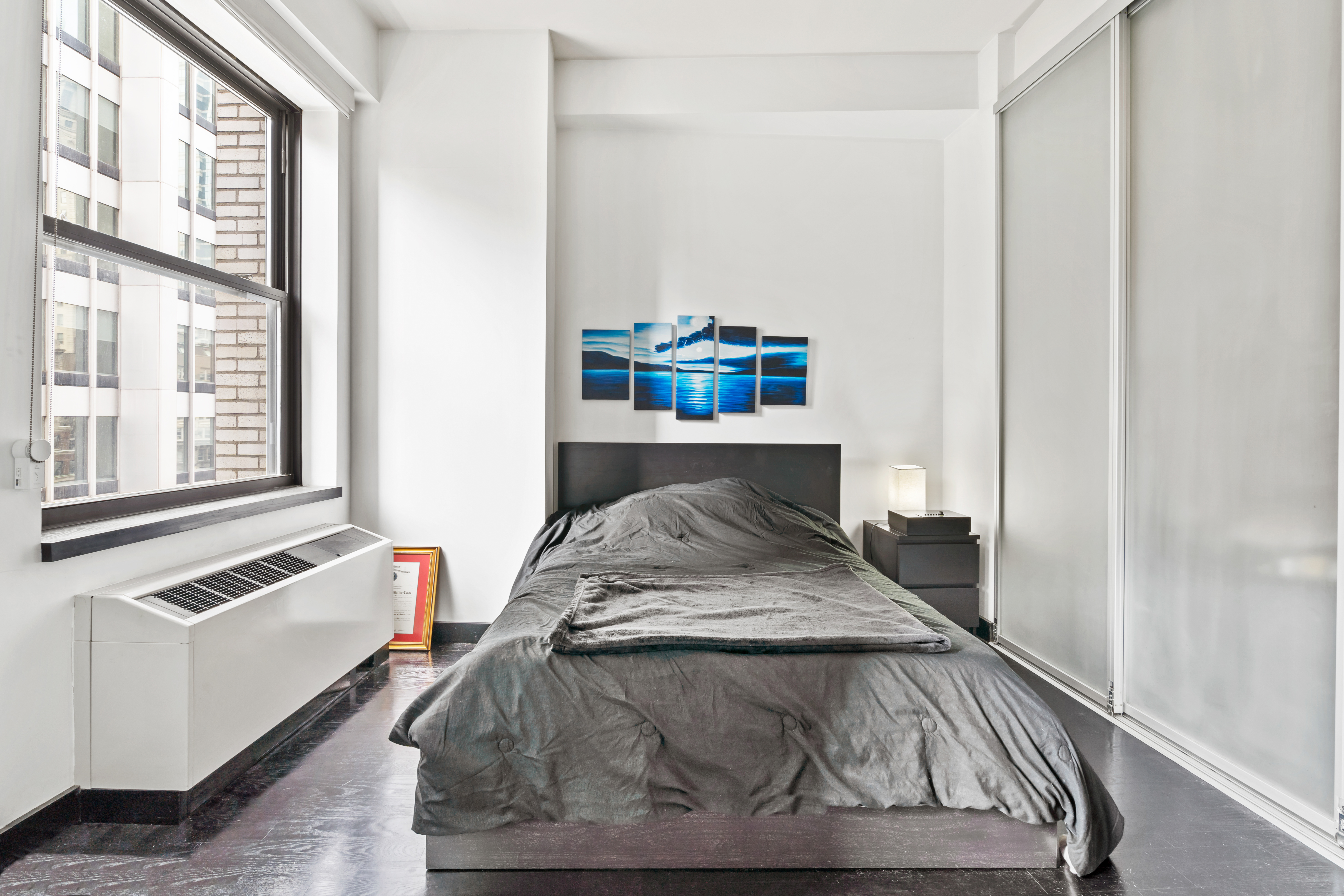 20 Pine Street, Unit 2012 Manhattan, NY 10005 - Photo 6 of 25 a living room with furniture and a window