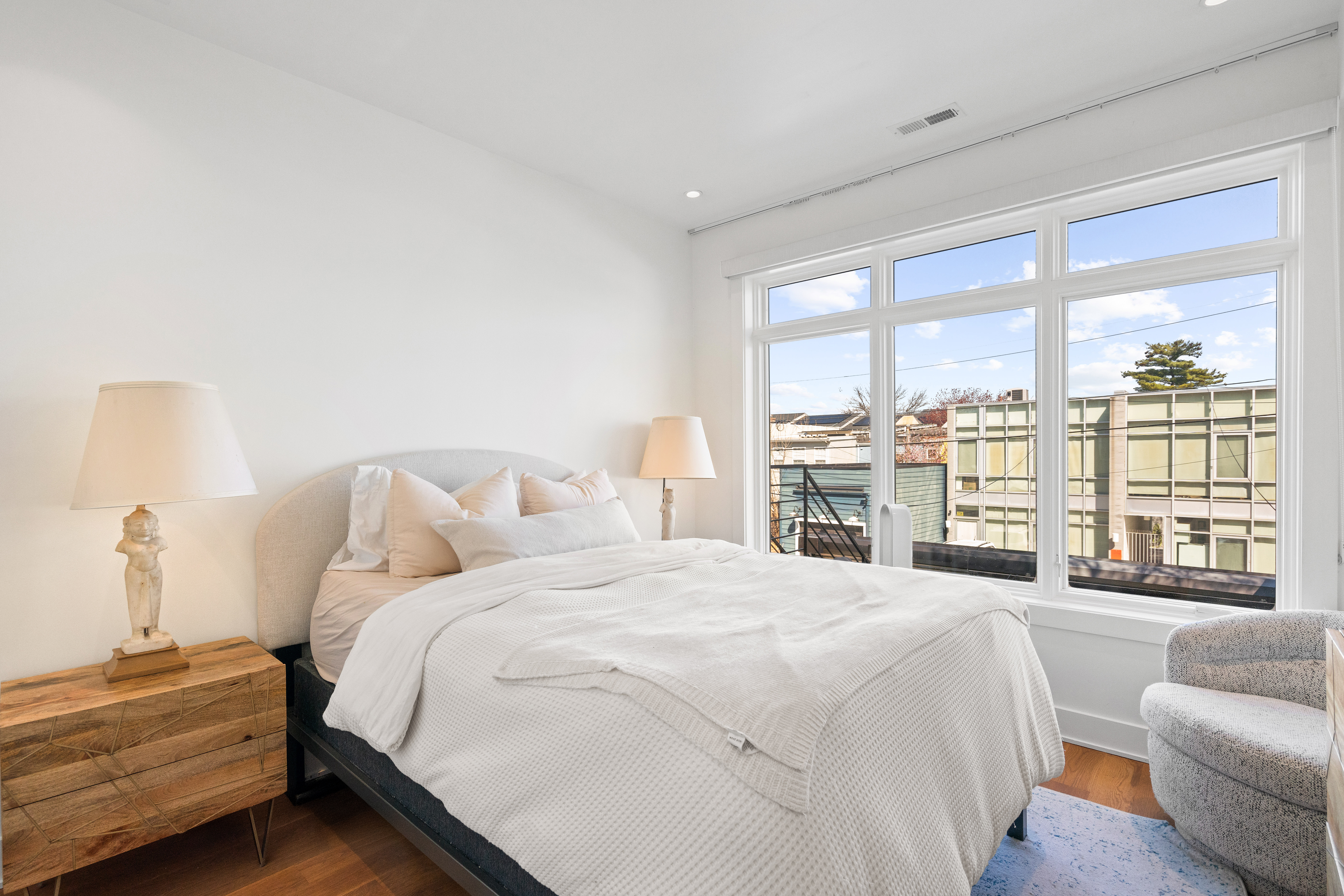 445 Ridge Street Northwest Washington, DC 20001 - Photo 30 of 43 a spacious bedroom with a bed and a large window