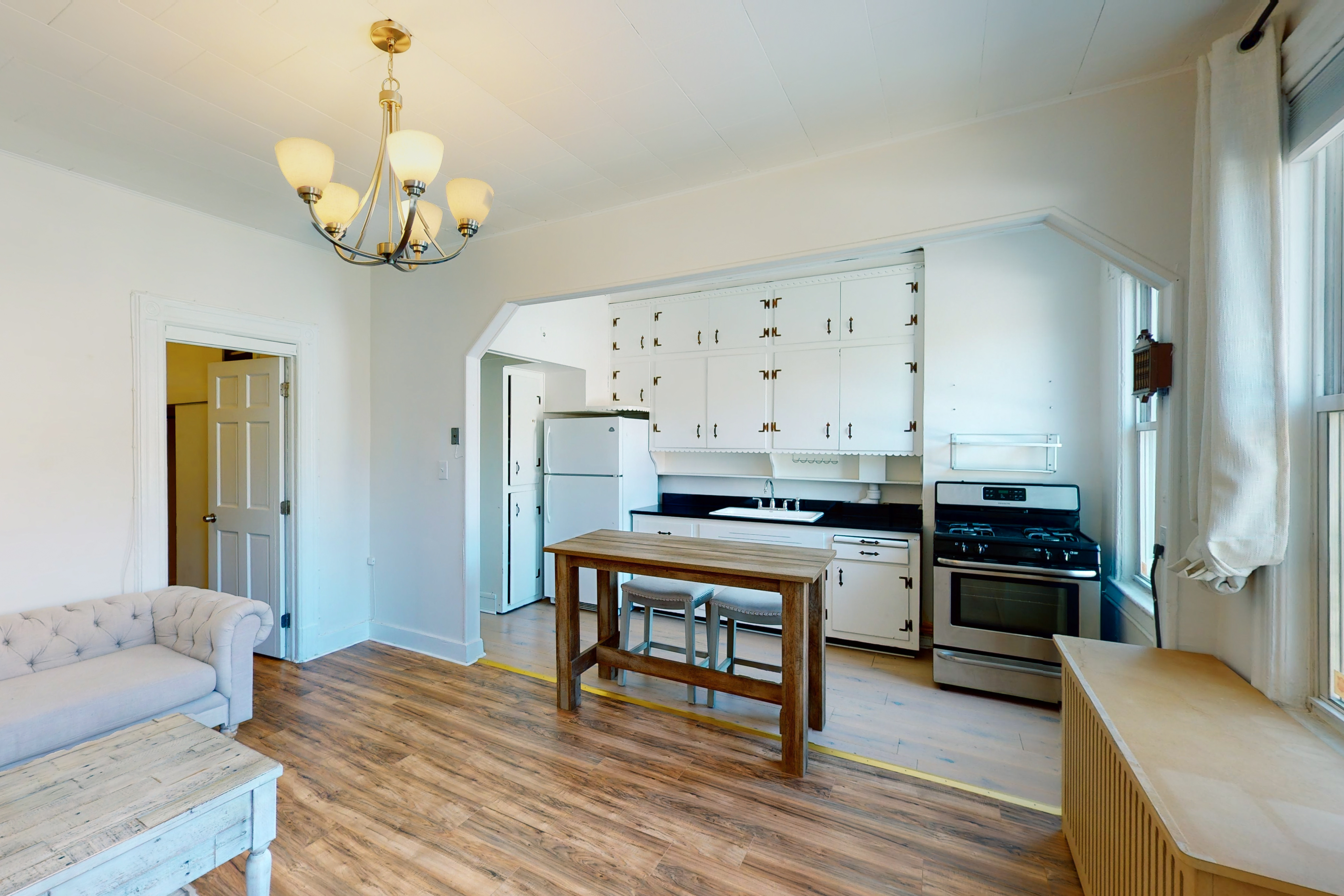 239 Withers Street, Unit 2 Brooklyn, NY 11211 - Photo 2 of 6 a living room with stainless steel appliances kitchen island granite countertop furniture and wooden floor