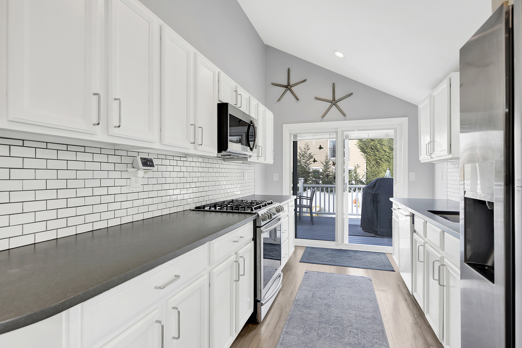 4-53 Beach 142nd Street Queens, NY 11694 - Photo 32 of 39 a kitchen with stainless steel appliances a sink stove and cabinets