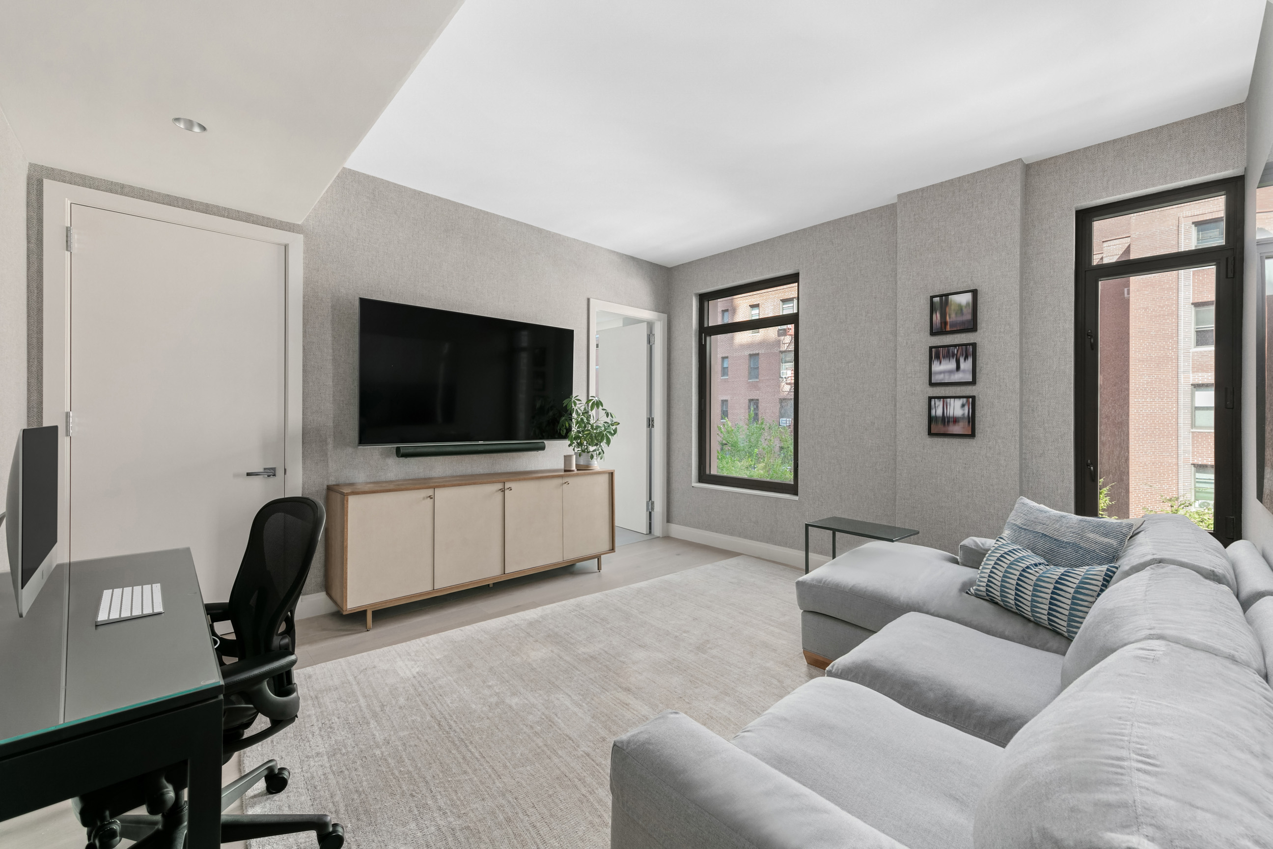 212 West 95th Street, Unit 4B Manhattan, NY 10025 - Photo 11 of 13 a living room with furniture and a flat screen tv